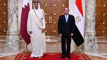 A handout picture released by the Egyptian Presidency shows President Abdel Fattah al-Sisi (R) receiving the Emir of Qatar Sheikh Tamim bin Hamad Al Thani at the presidential palace in the capital Cairo, on June 25, 2022. (AFP)