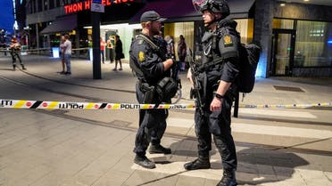 Security forces stand at the site where several people were injured during a shooting outside the London Pub in central Oslo, Norway, on June 25, 2022. (Reuters)