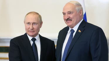 Russian President Vladimir Putin (L) shakes hands with his Belarusian counterpart Alexander Lukashenko during their meeting in Saint Petersburg, on June 25, 2022. (Sputnik/AFP)