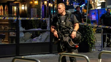 Security forces stand at the site where several people were injured during a shooting in central Oslo, Norway, on June 25, 2022. (Reuters)