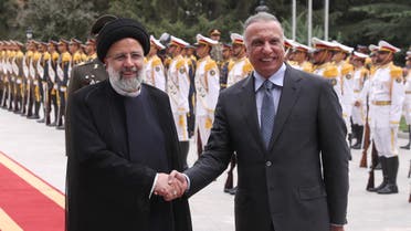 Iranian President Ebrahim Raisi shakes hands with Iraqi Prime Minister Mustafa al-Kadhimi during a welcoming ceremony in Tehran, Iran, June 26, 2022. (Reuters)