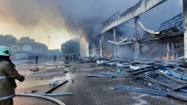 Firefighters putting out the fire in a mall hit by a Russian missile strike in the eastern Ukrainian city of Kremenchuk, June 27, 2022. (AFP)