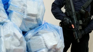A police officer stands guard in front of bags of heroin seized during a special operation, at a news conference in Kyiv, Ukraine April 24, 2019. (File photo: Reuters)