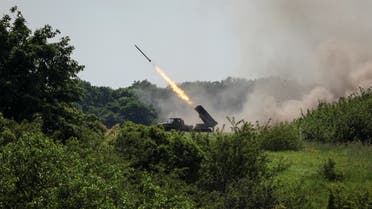 Ukrainian service members fire a BM-21 Grad multiple rocket launch system, near the town of Lysychansk, Luhansk region, amid Russia’s attack on Ukraine, on June 12, 2022. (Reuters)