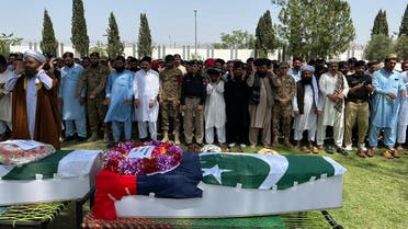 This handout picture taken on June 28, 2022 and released by the Pakistan’s Police Department shows Pakistan’s security officials offering funeral prayers for policemen who were killed along with a polio vaccinator by gunmen during a polio vaccination campaign in the North Waziristan district near Afghan border. (AFP)