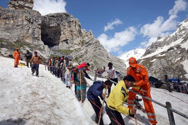 Hindu pilgrims leave the holy cave of Lord Shiva after worshipping in Amarnath, southeast of Srinagar. (Reuters)