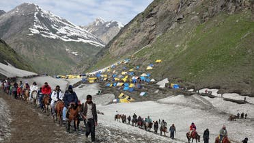 Hindu pilgrims trek through mountains to reach the Amarnath cave shrine where they worship an ice stalagmite that Hindus believe to be the symbol of Lord Shiva, at Sangam Top in the Kashmir region. (Reuters)