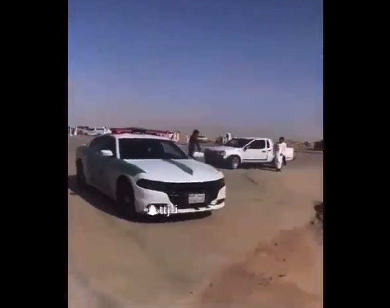 A security man stops the Muftah in Diriyah