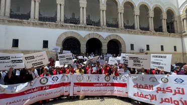 Tunisian judges carry banners during a protest against a decision by President Kais Saied to sack many of them, in Tunis, Tunisia June 23, 2022. Picture taken June 23, 2022. REUTERS/Jihed Abidellaoui
