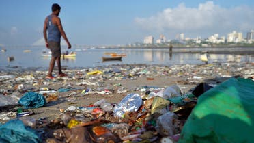 A man walks on a garbage-strewn beach in Mumbai, India, October 2, 2019. (Reuters)