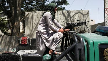 A Taliban fighter stands guard at the site where an explosive-laden vehicle detonated amidst an attack on a Sikh Temple in Kabul, Afghanistan, June 18, 2022. REUTERS/Ali Khara