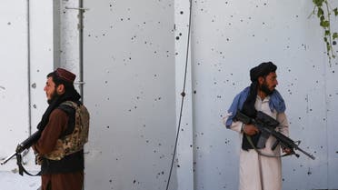 Taliban fighters stand guard at the site where an explosive-laden vehicle detonated amidst an attack on a Sikh Temple in Kabul, Afghanistan, June 18, 2022. REUTERS/Ali Khara