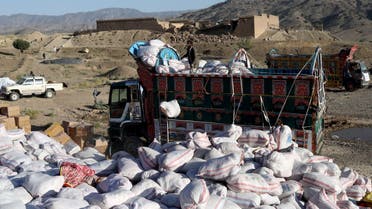 A man unloads packets of aid from a supply truck in the quake-hit area of Wor Kali village in the Barmal district of Paktika province, Afghanistan, June 25, 2022. (Reuters)
