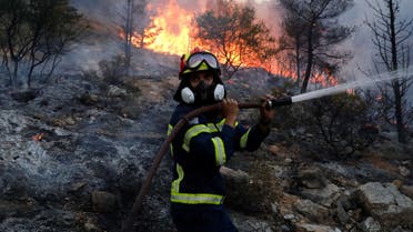 A firefighter tries to extinguish a wildfire near Vari, south of Athens, Greece June 4, 2022. (Reuters)