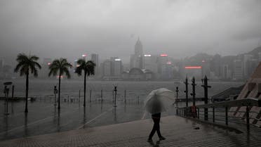 A person holding an umbrella walks in the rain at a waterfront, amid a typhoon warning on the 25th anniversary of the former British colony's handover to Chinese rule, in Hong Kong, China July 1, 2022. (File photo: Reuters)