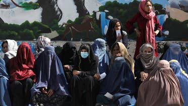 Afghan women wait to receive a food package being distributed by a Saudi Arabia humanitarian aid group at a distribution center in Kabul, Afghanistan, April 25, 2022. (Reuters)