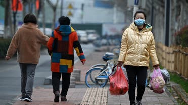1PQ0HO-highA woman wearing face mask, amid concerns about the spread of the COVID-19 novel coronavirus, walks along a street in Hefei, China’s eastern Anhui province on March 9, 2020. (File photo: AFP)res