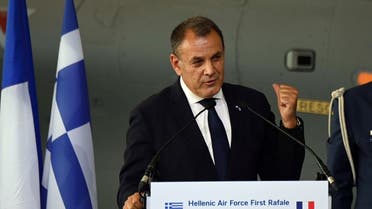Greek Defense minister Nikolaos Panagiotopoulos (C) gestures as he gives a speech during the handover ceremony of the first second hand French Rafale from Dassault enterprise to the Hellenic Air force, in Istres, Southern France, on July 21, 2021. (AFP)