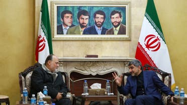  A file photo shows Hezbollah MP Ali Ammar (L) meeting with the Iranian Ambassador to Lebanon Mohammad Jalal Firouznia, under a painting of the four missing Iranian diplomats who disappeared during the 1982 Israeli invasion of Lebanon, at the Iranian embassy in the Lebanese capital Beirut on January 3, 2020. (AFP)