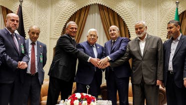 A handout picture provided by the Palestinian Authority’s press office (PPO) on July 5, 2022 shows (L to R) Palestinian President Mahmoud Abbas (C) meeting with Algerian President Abdelmajid Tebboune (C-R) and with Palestinian Hamas movement’s leader Ismail Haniyeh (2nd-R) during Abbas’ visit to attend Algeria’s 60th independence anniversary in its capital Algiers. (AFP)
