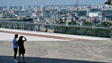 A couple walks in Ukrainian capital of Kyiv during a hot summer day on July 5, 2022, amid the Russian invasion of Ukraine. (File photo: AFP) 