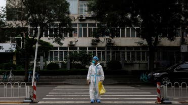 Medical worker in a protective suit crosses a street following a coronavirus disease (COVID-19) outbreak in Beijing, China, July 6, 2022. (Reuters)