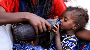 A severely malnourished child drinks from a bottle, at a camp for internally displaced people in Afdera town, Afar region, Ethiopia, February 23, 2022. Malnutrition is rising in the region, said the U.N. World Food Programme, and Afdera's camps are short of water, shelter and food. (Reuters)