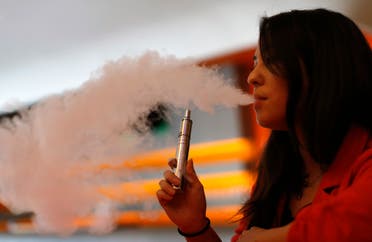 Enthusiast Brandy Tseu uses an electronic cigarette at The Vapor Spot vapor bar in Los Angeles, California March 4, 2014. (Reuters)