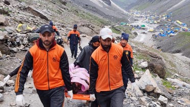 Rescuers carry a victim following a cloudburst near the holy Amarnath cave shrine in Kashmir July 9, 2022. (Reuters)