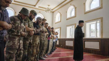 Former Mufti Sheikh Said Ismahilov, leads Muslim soldiers during prayers on the first day of Eid al-Adha, in Medina Mosque, Konstantinovka, eastern Ukraine, Saturday, July 9, 2022. Muslims around the world celebrate Eid al-Adha by sacrificing animals to commemorate the prophet Ibrahim's faith in being willing to sacrifice his son. (AP)