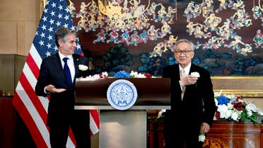 Thailand's Foreign Minister Don Pramudwinai and U.S. Secretary of State Antony Blinken display flowers on their jackets following remarks to the press after a Memorandum of Understanding signing ceremony at the Thai Ministry of Foreign Affairs in Bangkok, Thailand, July 10, 2022. (Reuters)