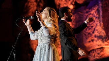 Lebanese singer Soumaya Baalbaki and conductor Lubnan Baalbaki perform at the Roman temple of Bacchus, during the opening of Baalbeck International Festival, in Baalbeck, Lebanon, on July 8, 2022. (Reuters)