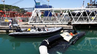 A punctured dinghy that was used by migrants to cross the English Channel is pulled into the Port of Dover, in Dover, Britain, on June 14, 2022. (Reuters)
