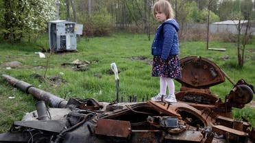 A child stands on a destroyed Russian tank, amid Russia's invasion of Ukraine, near Makariv, Kyiv region, Ukraine May 7, 2022. REUTERS/Mikhail Palinchak TPX IMAGES OF THE DAY