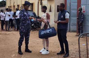 NCB Lome officers accompany the girl from police headquarters to her Burkina Faso flight. (Supplied)