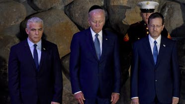 Israeli Prime Minister Yair Lapid, US President Joe Biden and Israeli President Isaac Herzog attend a memorial ceremony in the Hall of Remembrance at Yad Vashem, the World Holocaust Remembrance Center, in Jerusalem, on July 13, 2022. (Reuters)