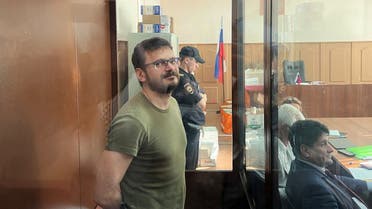 Russian opposition politician Ilya Yashin, detained on suspicion of spreading false information about Russia’s army, stands inside a defendants’ cage during a court hearing in Moscow, Russia, on July 13, 2022. (Reuters)
