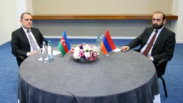 This handout picture taken and released by Georgian Ministry of Foreign Affairs on July 16, 2022 shows Foreign Minister of Azerbaijan Jeyhun Bayramov (L) and Armenian Foreign Minister Ararat Mirzoyan looking on during a meeting in Tbilisi, Georgia. (Georgian Ministry of Foreign Affairs/AFP)