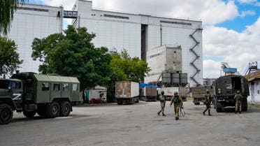 Russian soldiers guard an area in front of a grain elevator in Melitopol, south Ukraine, Thursday, July 14, 2022. About 300,000 tonnes of harvest have been collected in Melitopol district of Zaporizhzhia region. Russia took control of part of the Zaporizhzhia region quickly after the launch of the military operation in Ukraine. This photo was taken during a trip organized by the Russian Ministry of Defense. (AP Photo)