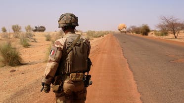A French soldier from Operation Barkhane stands on the road as he escorts the last convoys leaving Gossi, Mali April 17, 2022. Picture taken April 17, 2022. REUTERS/Paul Lorgerie