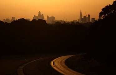A cyclist rides through Richmond Park at sunrise during a heatwave in London, Britain, July 18, 2022. (Reuters)