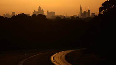 A cyclist rides through Richmond Park at sunrise during a heatwave in London, Britain, July 18, 2022. (Reuters)