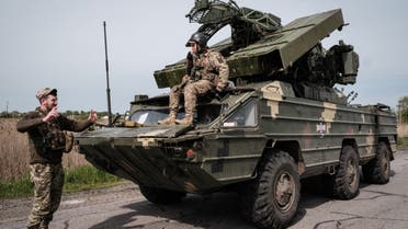 Ukrainian soldiers gesture around their anti aircraft missile system near Sloviansk, eastern Ukraine on May 11, 2022, amid the Russian invasion of Ukraine. (AFP)