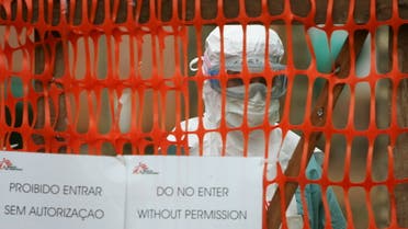A  health worker in protective clothing peers out from behind barriers marking the isolation ward where victims of the deadly Marburg virus are treated in the northern Angolan town of Uige. (File photo: Reuters)