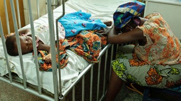 Hassana Ousmane rests her head against the bed where her 21-month-old daughter Zeinab, suffering from malaria and diarrhoea, rests at the Princess Marie Louise Children's Hospital in Accra. (File photo: Reuters)
