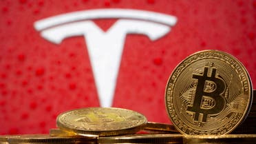Representations of virtual currency bitcoin are seen in front of Tesla logo in this illustration taken, February 9, 2021. (File photo: Reuters)