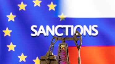 A model of a pump jack is seen in front of the displayed word Sanctions, U.S. and Russia flag colours in this illustration taken March 8, 2022. (Reuters)