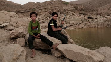 FILE - A 17 year-old boy holds his weapon at the High dam in Marib, Yemen, July 30, 2018. emen’s Houthi rebels continue to recruit children into their military ranks to fight in the country’s civil war, despite an agreement with the U.N. in April 2022, to halt the practice. Two Houthi officials acknowledged to the Associated Press that the rebels have recruited several hundred children, some as young as 10, in the past two months. (AP Photo/Nariman El-Mofty, File)