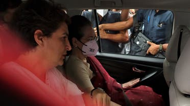 President of India's main opposition Congress party Sonia Gandhi, wearing face mask, sits in a car with her daughter and a leader of the party Priyanka Gandhi Vadra as she leaves the party headquarters for her summons at the Enforcement Directorate (ED) in a money laundering case, in New Delhi, India, on July 21, 2022. (Reuters)