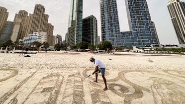 Sand artist Nathaniel Alapide draws on the beach in Dubai, United Arab Emirates July 20, 2022. (Reuters)